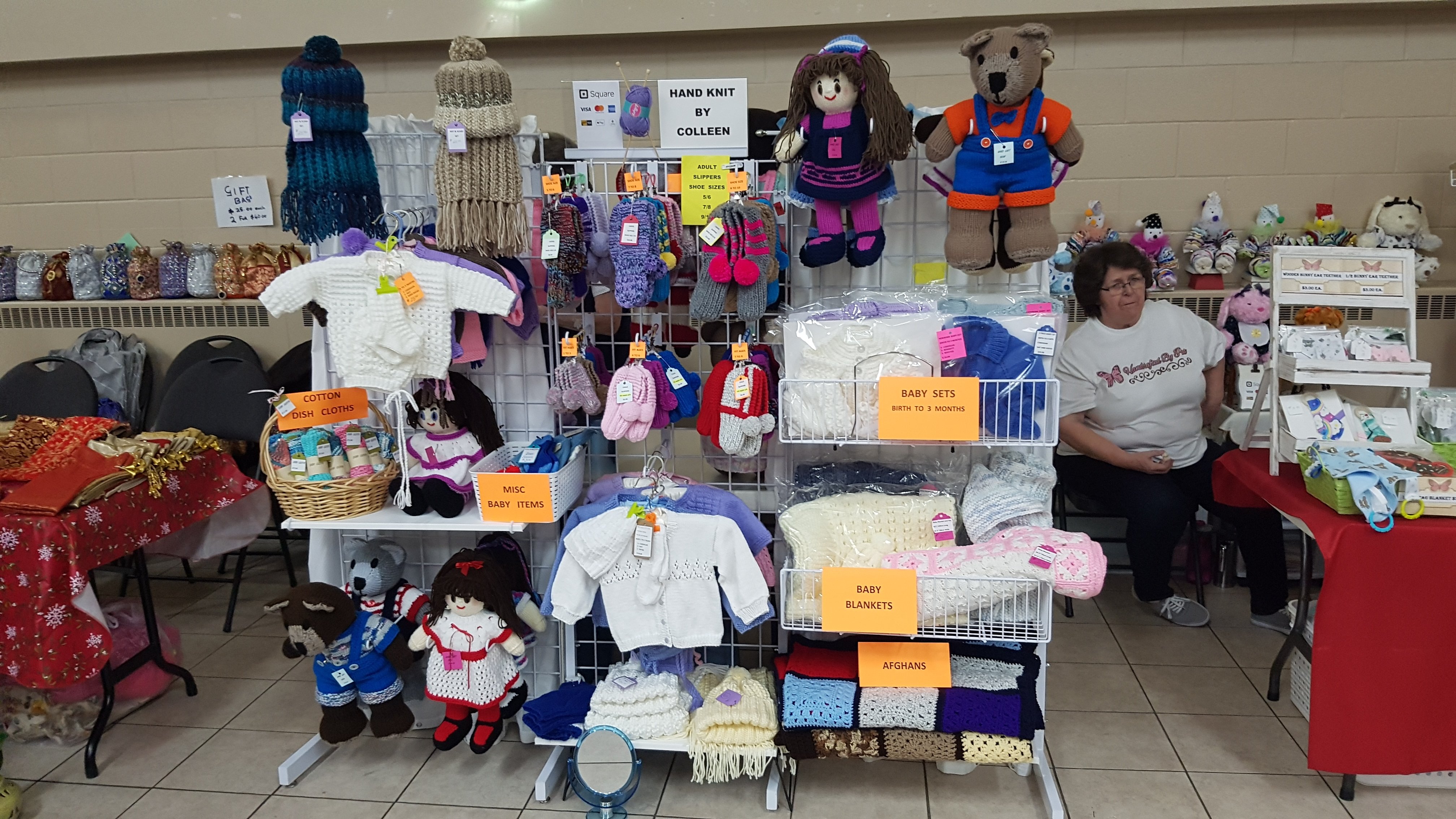picture of vendor selling knitted items for babies