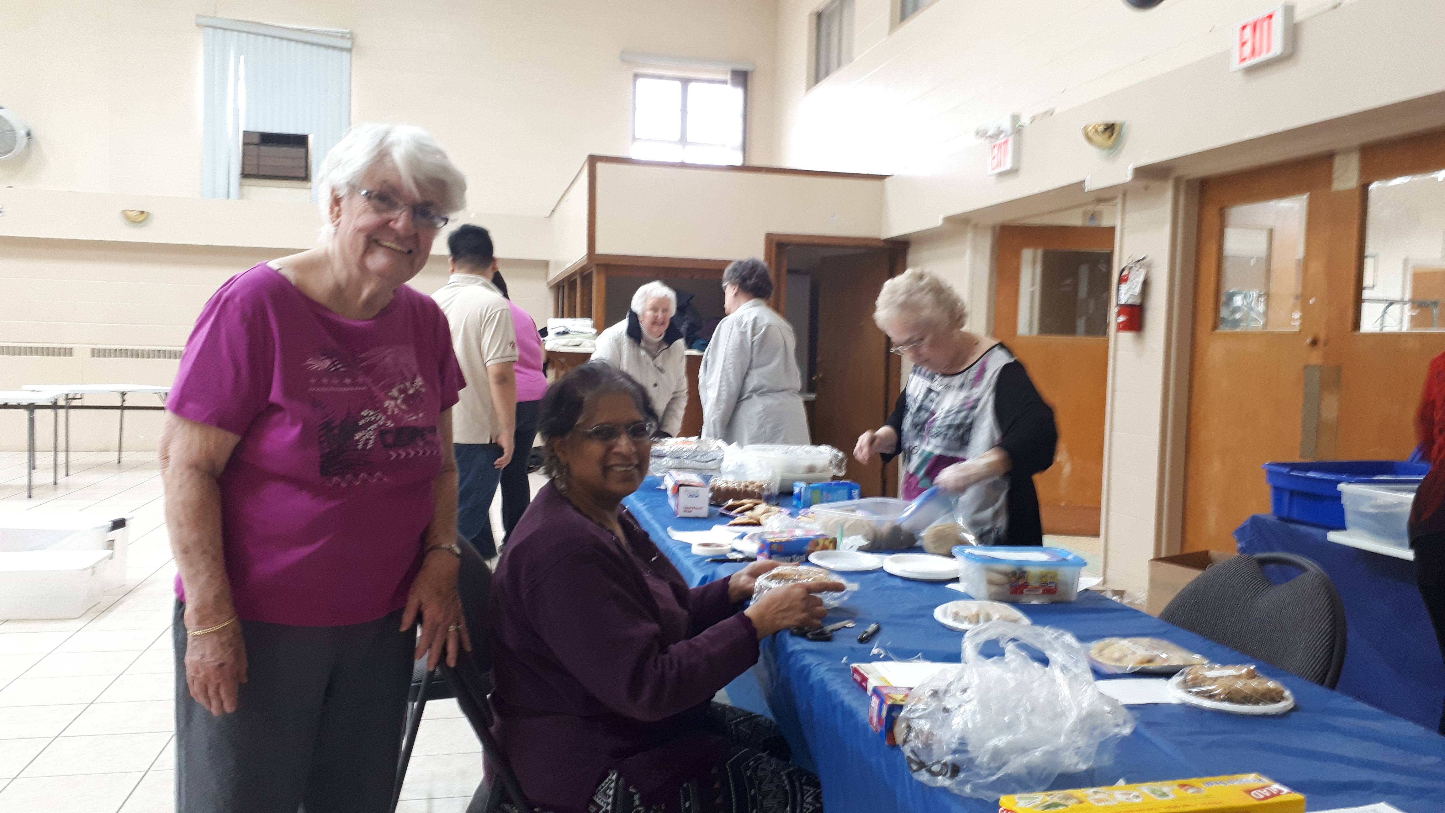 members and shoppers at baking table