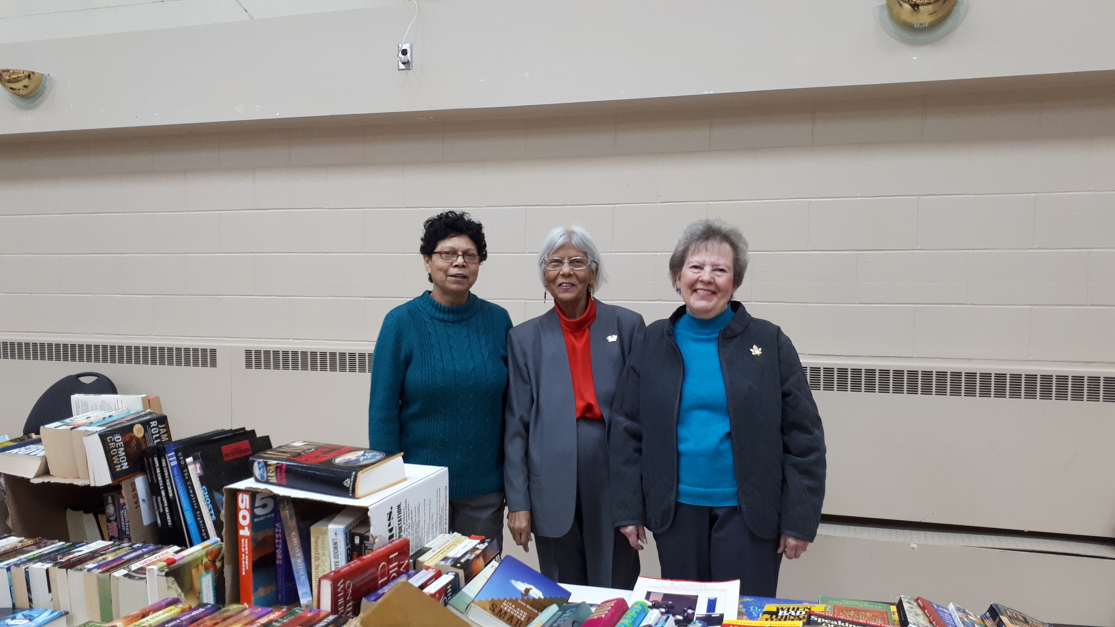 cwl members helping at the book table