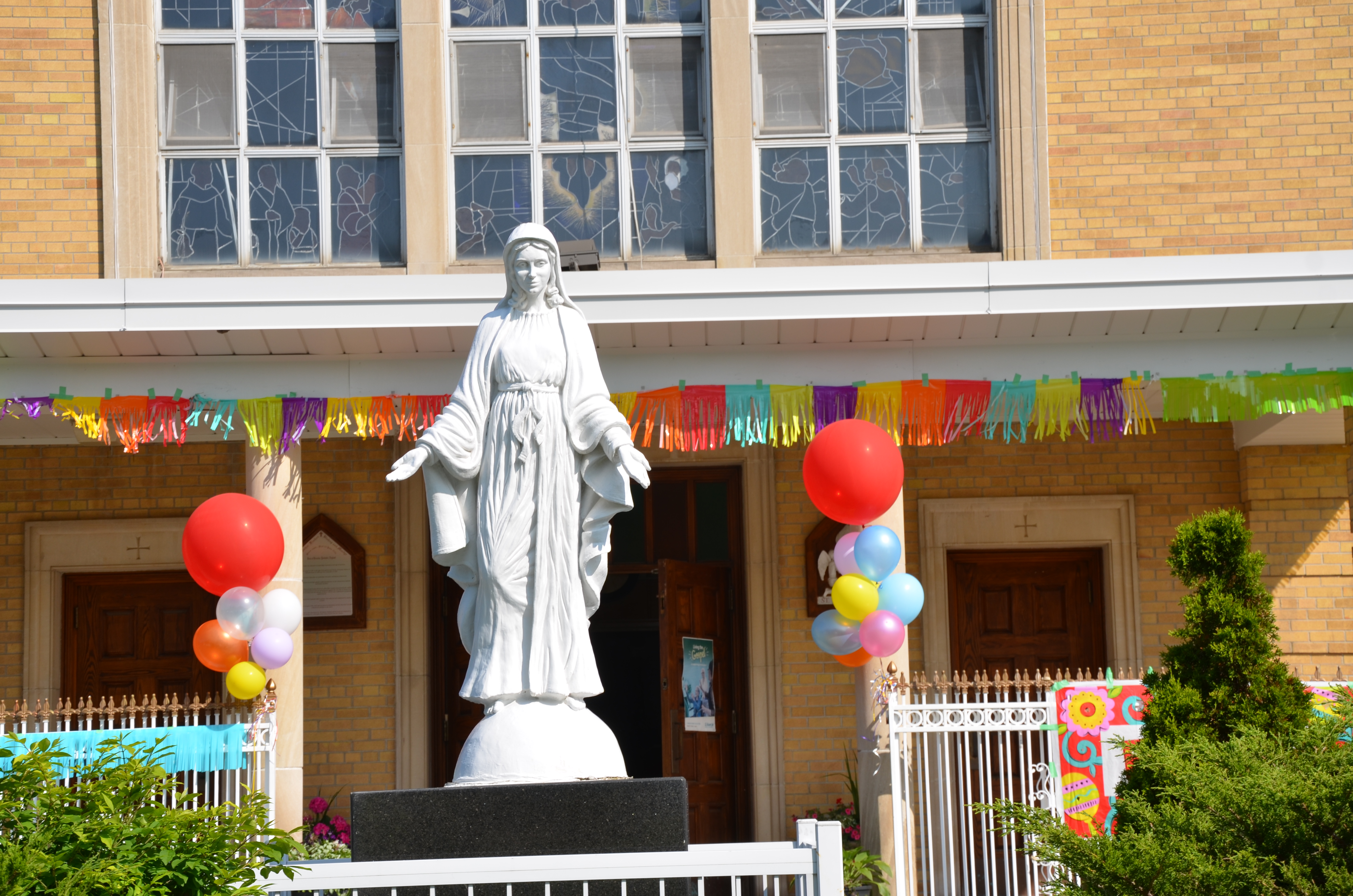 picture of front of church focusing on the Mary statue